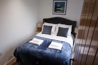 a bedroom with a large bed with two pillows at The Granary Estates