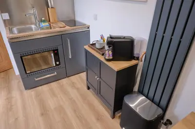 a small kitchen with a stove and a microwave at The Granary Estates