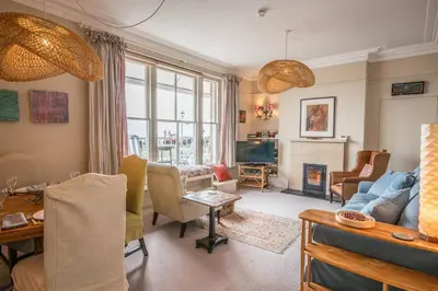 a living room with a couch and a fireplace at 11b Market Cross Place, Aldeburgh in Aldeburgh