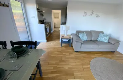 a living room with a couch and a table at Woodstock Park The Tawny Lodge in Wereham