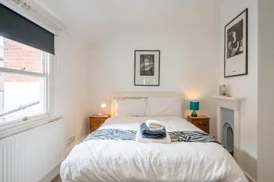 a bedroom with a bed with a hat on it at Orlando, Aldeburgh in Aldeburgh