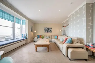 a living room with a couch and a table at Orlando, Aldeburgh in Aldeburgh