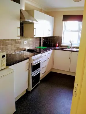 a small kitchen with white appliances and a window at Bungalow in Cambridge- 3 bedrooms in CBG
