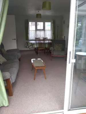 a living room with a couch and a table at Bungalow in Cambridge- 3 bedrooms in CBG