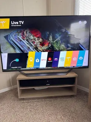 a flat screen tv sitting on top of a stand at Cosy Little Home By The Sea in West Mersea