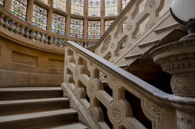 a staircase in a building with a stained glass window at The Hobson Cambridge by Adina in Cambridge