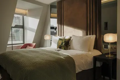 a hotel room with a bed and a window at The Hobson Cambridge by Adina in Cambridge