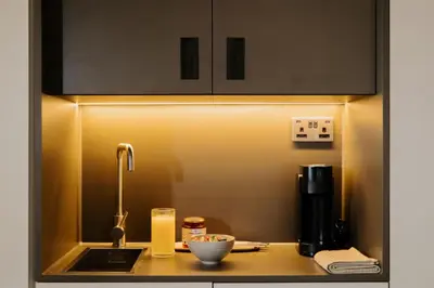 a kitchen counter with a sink and a coffee maker at The Hobson Cambridge by Adina in Cambridge