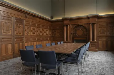 a conference room with a large wooden table and chairs at The Hobson Cambridge by Adina in Cambridge