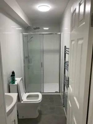 a bathroom with a shower and a toilet and a sink at Bronze house in Friern Barnet