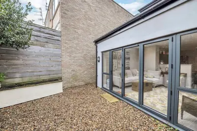 a room with sliding glass doors leading to a bedroom at GROUND floor apartment no steps 119 Northgate St luxury 2 bedroom apartment close to the town centre with paid parking close by in Bury Saint Edmunds