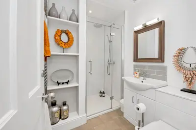 a bathroom with a shower and a toilet and a sink at GROUND floor apartment no steps 119 Northgate St luxury 2 bedroom apartment close to the town centre with paid parking close by in Bury Saint Edmunds