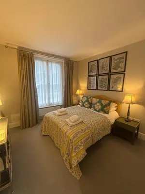 a bedroom with a bed and a window at GROUND floor apartment no steps 119 Northgate St luxury 2 bedroom apartment close to the town centre with paid parking close by in Bury Saint Edmunds