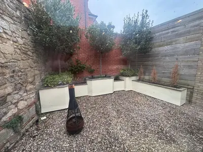 a bottle of wine sitting on the ground in a courtyard at GROUND floor apartment no steps 119 Northgate St luxury 2 bedroom apartment close to the town centre with paid parking close by in Bury Saint Edmunds