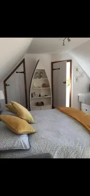 a bedroom with a bed with two pillows on it at Sunnyside Cottage in Great Sampford