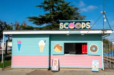 a colorful ice cream shop with a sign on it at Coastal Retreats in Great Clacton