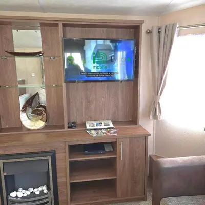 a entertainment center with a television in a living room at Coastal Retreats in Great Clacton