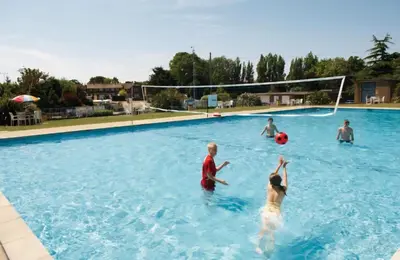 a group of people playing frisbee in a swimming pool at Coastal Retreats in Great Clacton