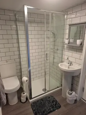 a bathroom with a shower and a toilet and a sink at Als air b and b in Cherry Hinton