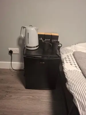 a blender sitting on top of a cabinet next to a bed at Als air b and b in Cherry Hinton