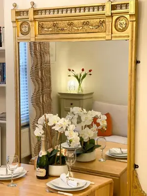 a mirror on a table with plates and glasses at Luxury Boutique 'Duchess Suite' in Historic Centre in Cambridge