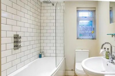 a bathroom with a tub and a sink and a toilet at Luxury Boutique 'Duchess Suite' in Historic Centre in Cambridge