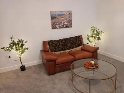a living room with a couch and a glass table at Stylish 1 Bed Flat Parking Walk to Waterfront in Ipswich