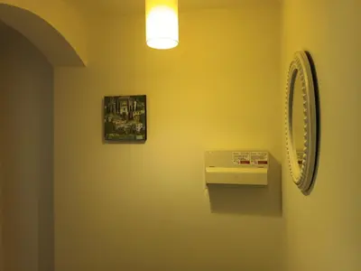 a bathroom with a mirror and a sink on a wall at Stylish 1 Bed Flat Parking Walk to Waterfront in Ipswich