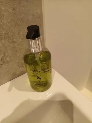 a bottle of olive oil sitting on top of a sink at Stylish 1 Bed Flat Parking Walk to Waterfront in Ipswich