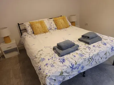a bed with two pillows on it in a bedroom at Stylish 1 Bed Flat Parking Walk to Waterfront in Ipswich