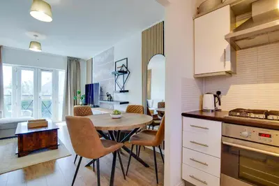 a kitchen and dining room with a table and chairs at Pass the Keys Stylish and Modern Flat with Free Parking in Cambridge