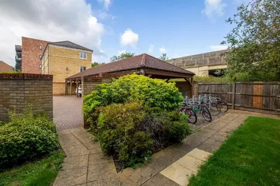 a garden with two bikes parked next to a fence at Pass the Keys Stylish and Modern Flat with Free Parking in Cambridge
