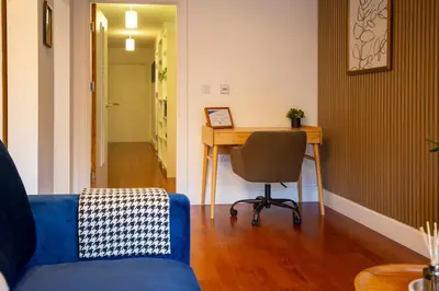 a living room with a blue couch and a desk at Pass the Keys Stylish Riverside Apartment with Free Parking in Cambridge