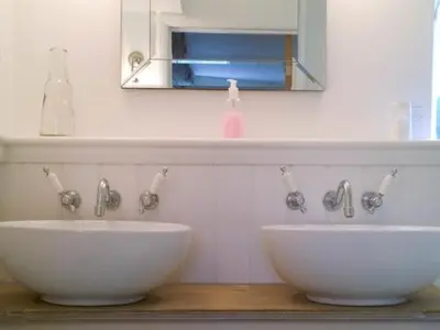 a bathroom with two white sinks and a mirror at Guest Rooms at The Green Man in Takeley