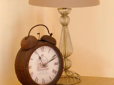 a clock sitting on a table next to a lamp at Guest Rooms at The Green Man in Takeley