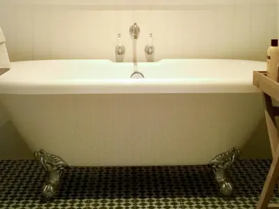 a bath tub with a sink in a bathroom at Guest Rooms at The Green Man in Takeley
