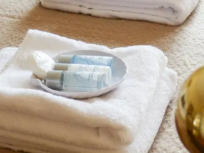 a pile of soap on a plate on a towel at Guest Rooms at The Green Man in Takeley