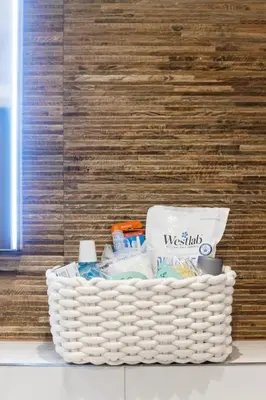 a basket of toiletries sitting on the floor in a room at Stonebridge House Apartment in Chelmsford