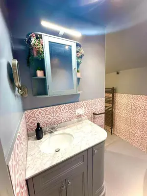 a bathroom with a sink and a mirror at Coastal Lodge in Leiston