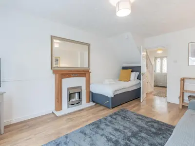 a bedroom with a bed and a fireplace at Pass the Keys Cosy home Basildon Ideal for contractors in Basildon