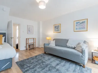 a living room with a couch and a bed at Pass the Keys Cosy home Basildon Ideal for contractors in Basildon