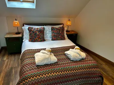 a hotel room with a bed with towels on it at Luxury Retreat with Spa Access - Sleeps 6 in Peldon