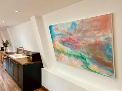 a painting hanging on a wall in a kitchen at Luxury Retreat with Spa Access - Sleeps 6 in Peldon