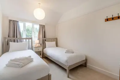 a bedroom with two beds and a window at 2 Bed in Knodishall oc-s33543 in Friston