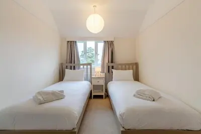 two twin beds in a room with a window at 2 Bed in Knodishall oc-s33543 in Friston