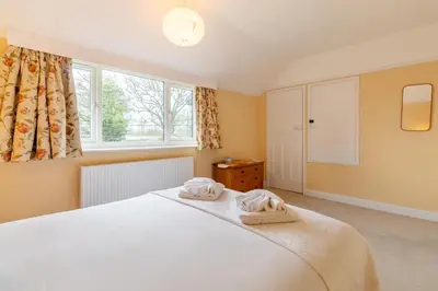 a bedroom with a white bed and a window at 2 Bed in Knodishall oc-s33543 in Friston