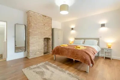 a bedroom with a large bed and a brick wall at 2 Bed in Fincham oc-t33561 in Fincham