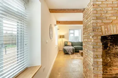 a living room with a brick fireplace and a couch at 2 Bed in Fincham oc-t33561 in Fincham