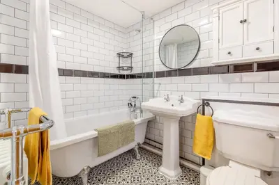 a white bathroom with a tub sink and a toilet at 2 Bed in Fincham oc-t33561 in Fincham