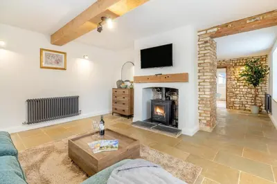 a living room with a fireplace and a tv at 2 Bed in Fincham oc-t33561 in Fincham